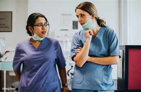 Nurses Having A Conversation In The Icu Free Image By