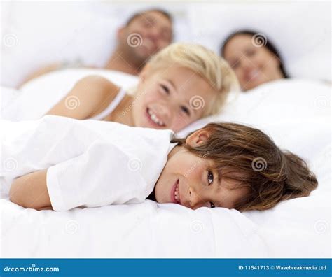 family resting  parent  bed stock image image  brother people