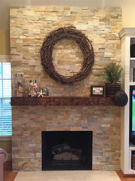 carr family fireplace wrapped  dry stacked stone veneers basement