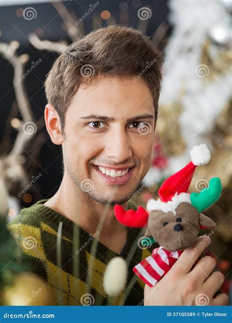 man holding stuffed toy  christmas store royalty  stock images
