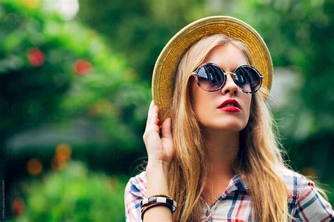 portrait of a beautiful blonde woman with sunglasses by stocksy