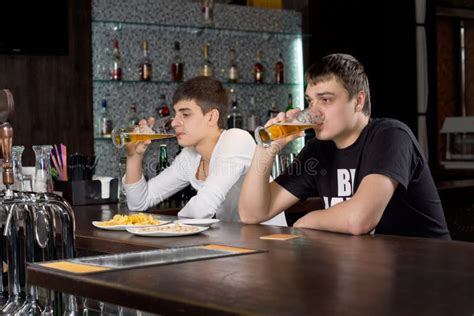 men relaxing   bar drinking beer stock photography image