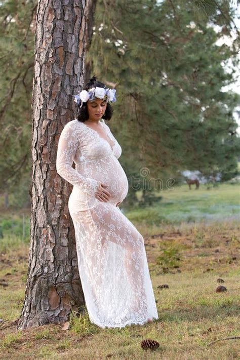 Beautiful Pregnant Woman In White Sheer Maternity Dress Outdoors Stock