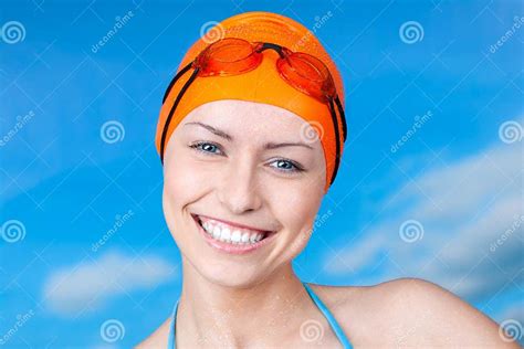 A Winner Young Female Swimmer In An Orange Swimming Cap And Swimming