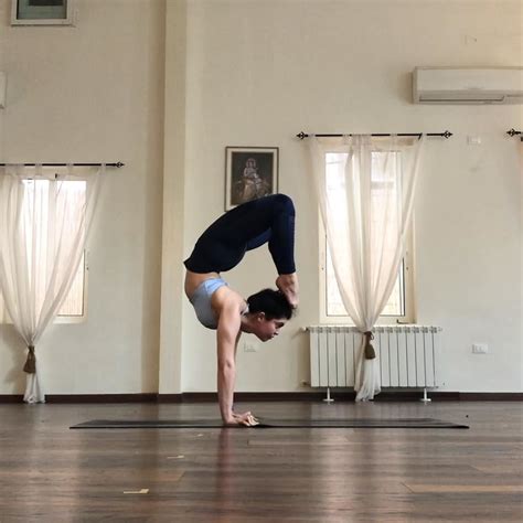 hold scorpion pose  holding  straight handstand