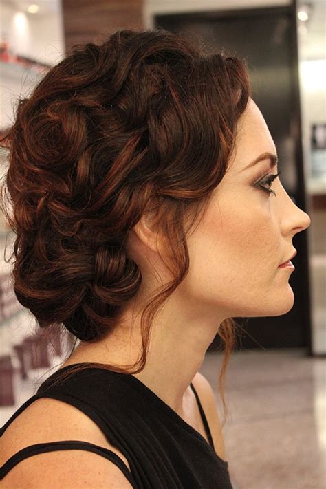 soft romantic curls pulled into a loose updo create a