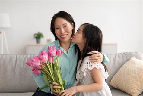 premium photo cute asian girl kissing cheerful grandmother giving her