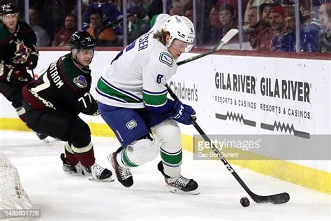 brock boeser of the vancouver canucks skates with the puck against