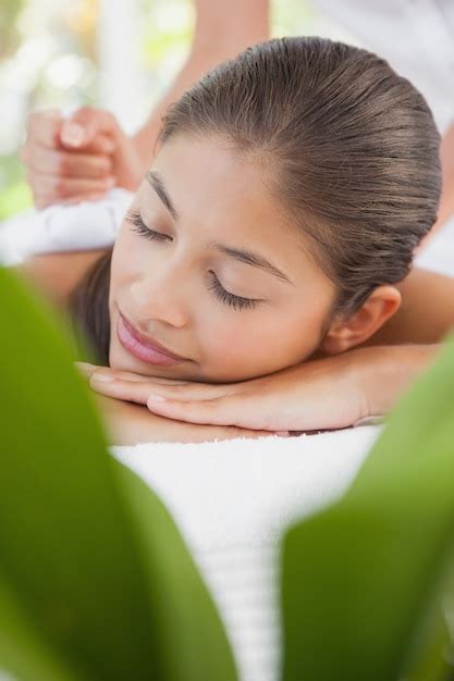 Premium Photo Beautiful Brunette Enjoying A Herbal Compress Massage
