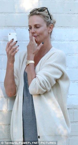 charlize theron kisses her phone during video chat with mystery caller in hollywood daily mail