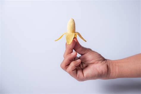 premium photo  small banana  hand