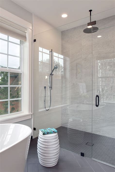 A Bathroom With A Tub Shower And Window