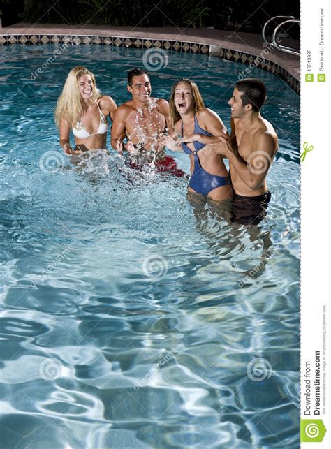 Two Couples In Swimming Pool At Night Royalty Free Stock