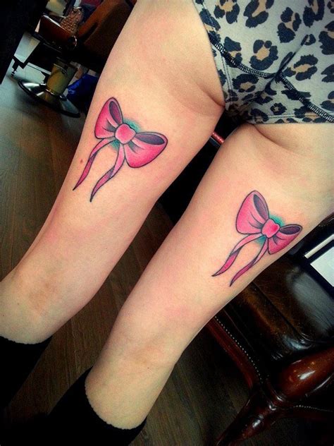 Two Women With Matching Tattoos On Their Legs One Has A Pink Bow And