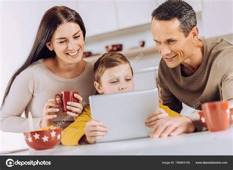 happy family watching video  tablet  stock photo  dmyrtoz