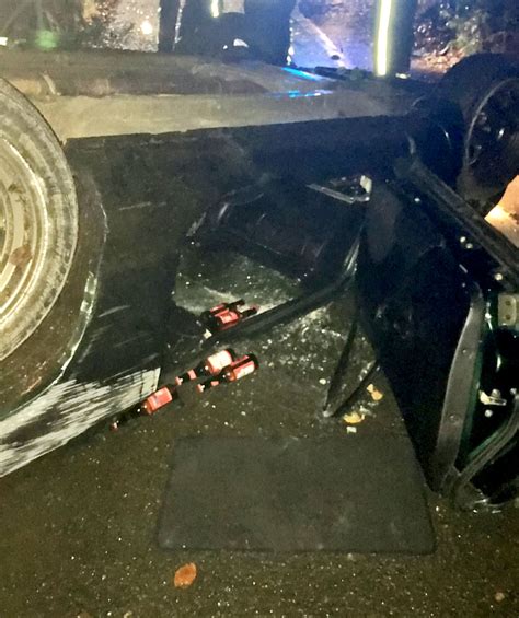 beer bottles roll from wreckage of drink driving crash in