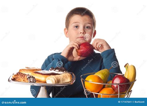 boy choosing  healthy apple stock image image  donuts concept