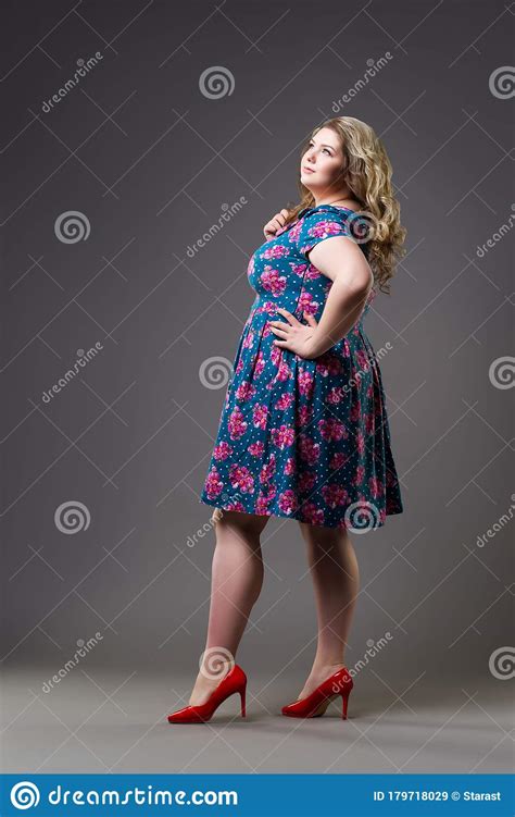 plus size fashion model in floral dress fat woman on gray background