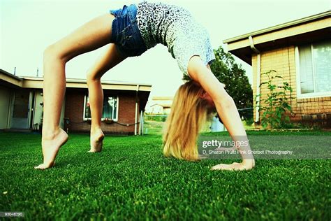 Girl Bending Over Backwards Arch In Grass Photo Getty Images