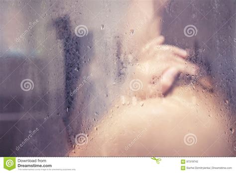 girl in shower behind glass with drops stock image image