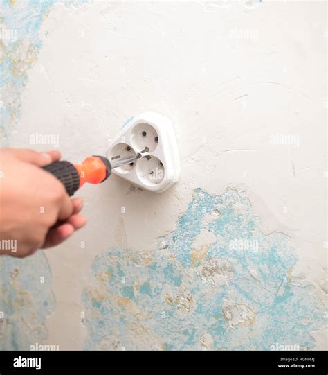 wall light switch installation   screwdriver stock photo alamy