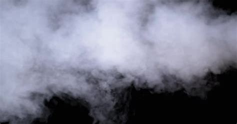 water vapor white jet  vapour steam  black background slow motion