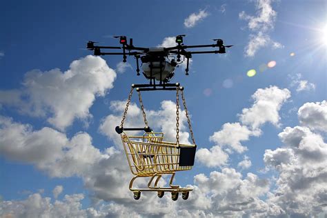 white black drone lifting yellow shopping cart daytime logistics