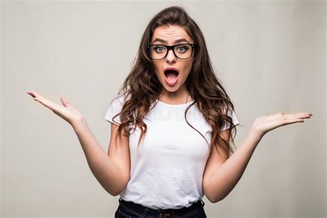 Surprised Shocked Young Woman Standing With Opened Mouth Over Grey
