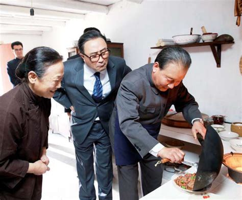 in a scene from the new production deng cooks a dish at a civilian s house