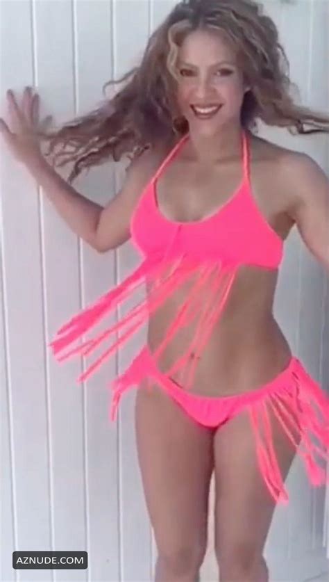 shakira flaunts her curves in a neon pink bikini that she