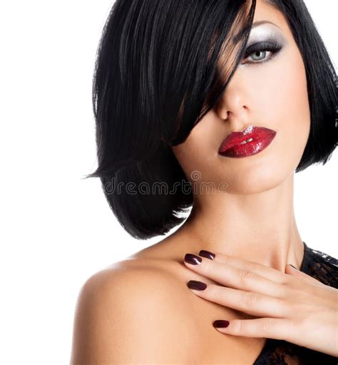 face of a woman with beautiful dark nails and red lips