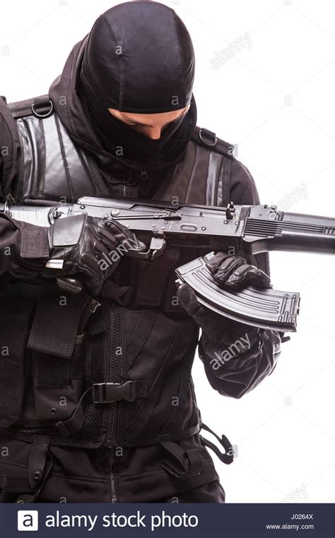 swat officer with assault rifle in black uniform isolated