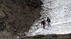 People walking on spring snow tongues to reach Dodital