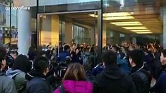 Apple employees cheer to welcome customers waiting for iPhone X in Beijing