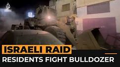 Palestinian residents confront Israeli bulldozer during raid