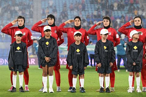 Iran women’s football team sing anthem amid safety concerns during war