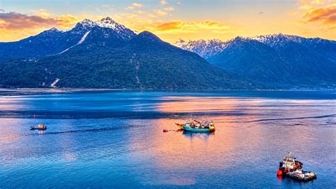 A remote village with boats and mountains in Patagonia Chile