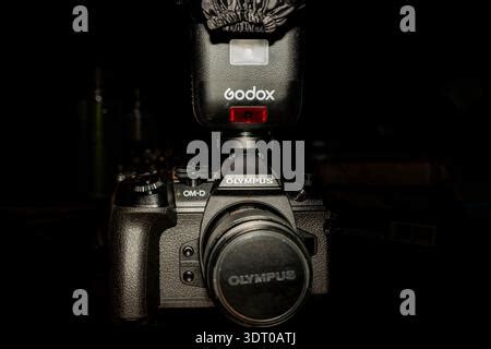 Macro closeup of Godox flash unit branding on black surface showing ...