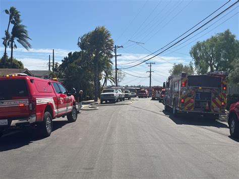 Brush fire fueled by strong winds threatens homes near Mission Valley ...