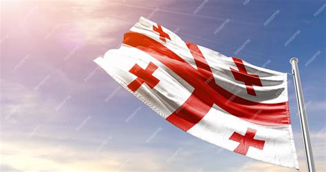 Premium Photo | Georgia flag waving in the beautiful sky