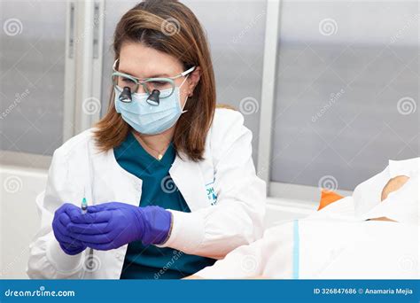 Dermatologist Carrying Out a Skin Biopsy on the Face of a Senior Adult ...