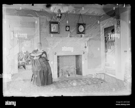 Woman sitting next to fireplace reading a book , People. Hingham Public ...