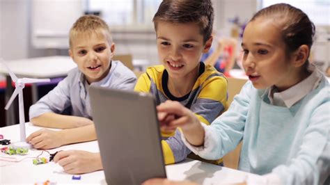 Group Of School Kids With Tablet Pc In Classroom Stock