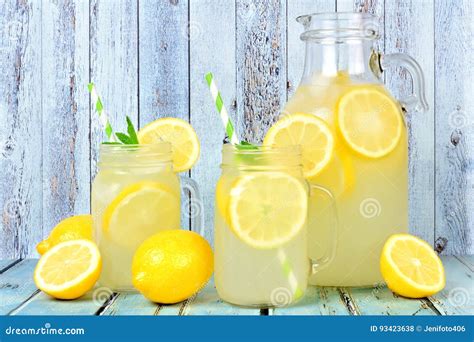 Vintage Pitcher Of Lemonade With Mason Jar Glasses On Rustic Blue Wood ...