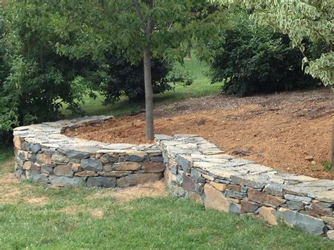 Dry stack field stone retaining wall on gravel bed : r/stonemasonry