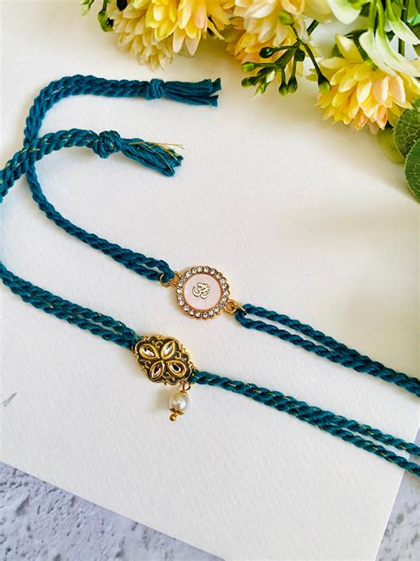 Om White And Meena Kundan Bhai Bhabhi Rakhi set – Madhurya Rakhi