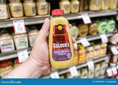 Shoppers Hand Holding a Plastic Container of Gulden`s Brand Spicy Brown ...
