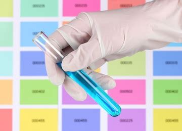 Tube with blue liquid in hand on color samples background | Premium Photo