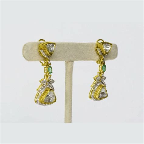 A fusion-style three-line necklace and earring set featuring diamond p ...