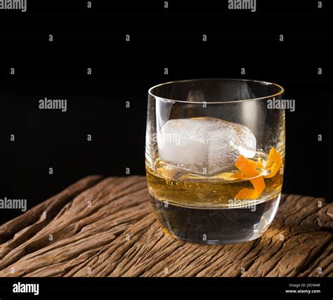 Glass of Scotch whisky on an old rustic wooden background. Modern ...